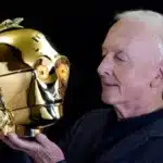 Anthony Daniels, famed for playing C-3PO in Star Wars, auctions his memorabilia, including the iconic gold helmet, scripts, and more, sharing his legacy with fans.