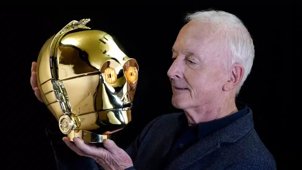 Anthony Daniels, famed for playing C-3PO in Star Wars, auctions his memorabilia, including the iconic gold helmet, scripts, and more, sharing his legacy with fans.