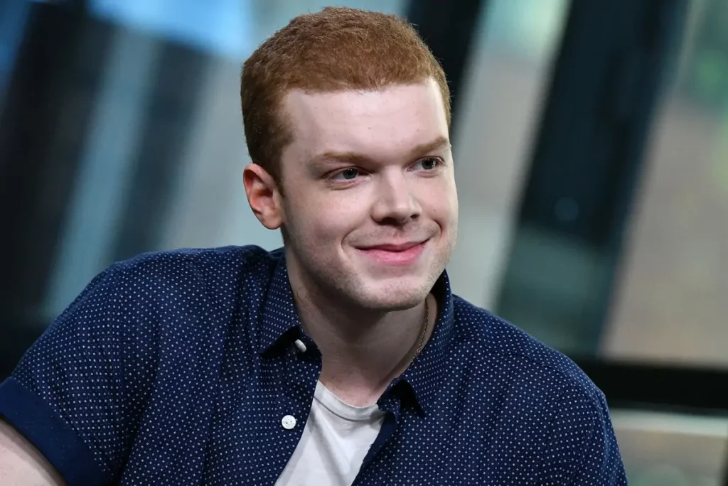 Cameron Monaghan being interviewed by a journalist, discussing his experience and challenges in playing Cal Kestis in Star Wars Jedi: Fallen Order.