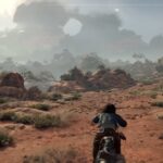 Motorcyclist riding through rugged desert landscape