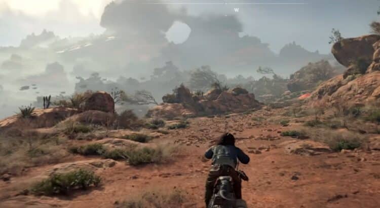 Motorcyclist riding through rugged desert landscape