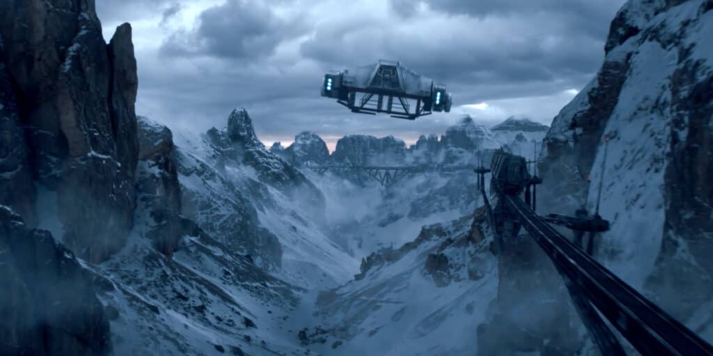 Futuristic vehicle flying over snowy mountainous landscape