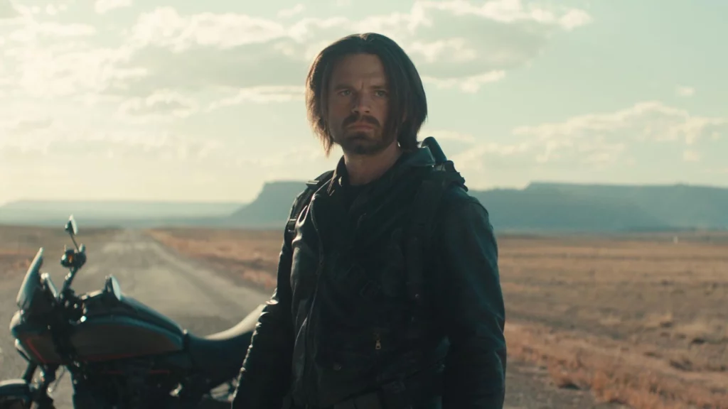 Bucky Barnes standing in the desert with his motorcycle, ready for action.