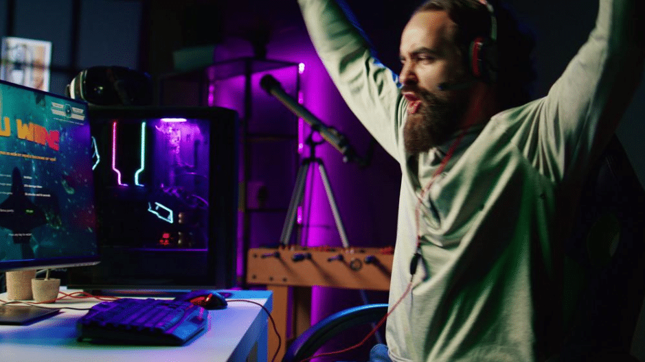 Modern home gaming setup with ergonomic chair, LED lighting, dual monitors, and ambient backlighting in a dedicated game room.