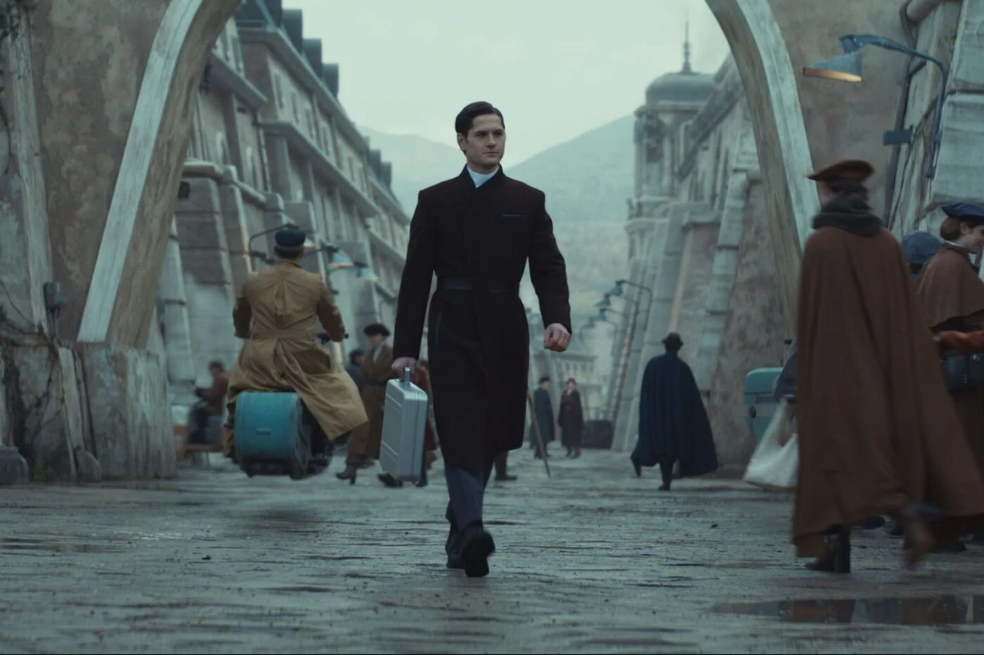 Syril Karn walking the streets of Ferrix in Andor, representing his rigid belief in order and justice. His path intersects with the Rebellion, leading to tragic consequences.
