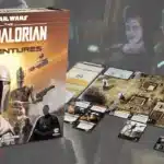 Board setup for Star Wars: The Mandalorian Adventures game with cards, tokens, and a mission map.