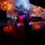 BB-9E droid in Battlefront II with fire and destruction in the background