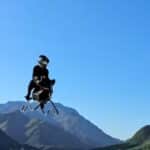 Jet-powered Volonaut Airbike flying through a mountain valley during a real-world test flight.