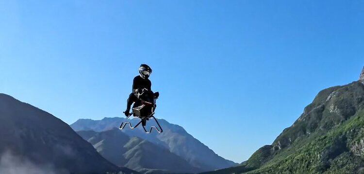 Jet-powered Volonaut Airbike flying through a mountain valley during a real-world test flight.