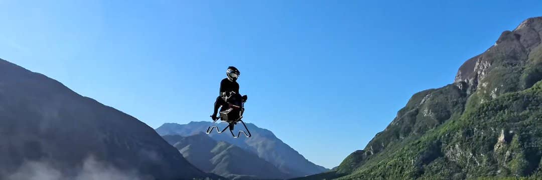 Jet-powered Volonaut Airbike flying through a mountain valley during a real-world test flight.