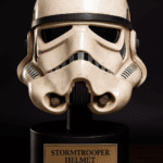 Original stormtrooper helmet from Star Wars: A New Hope on a black pedestal with brass nameplate