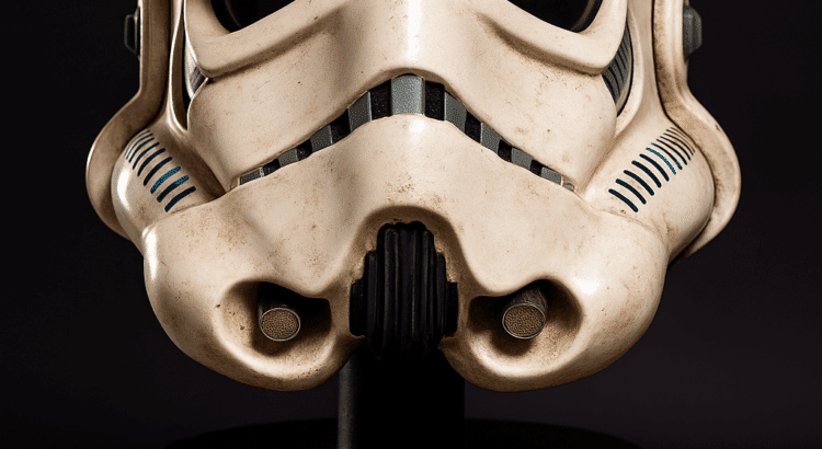 Original stormtrooper helmet from Star Wars: A New Hope on a black pedestal with brass nameplate