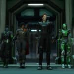 Four SWTOR characters walk side-by-side through a futuristic corridor in full gear