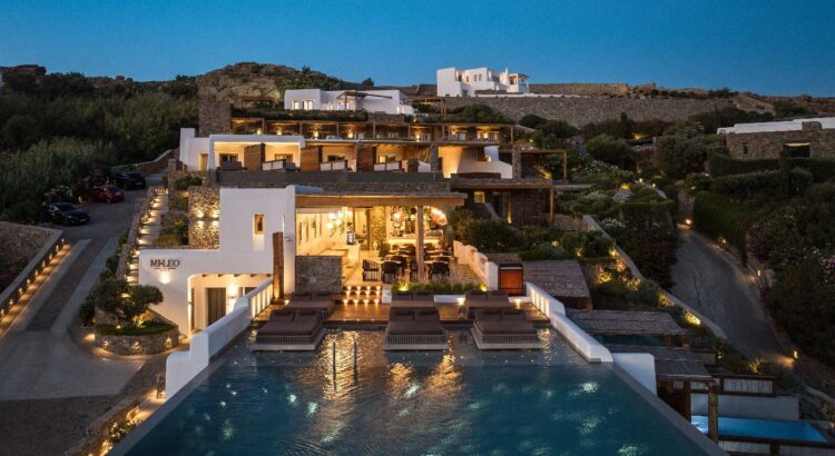 Luxury Boutique Hotel in Mykonos with infinity pool and illuminated Cycladic architecture at dusk