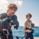 Ryan Gosling and Flynn Gray aboard a water vessel on location in Sardinia filming Star Wars: Starfighter