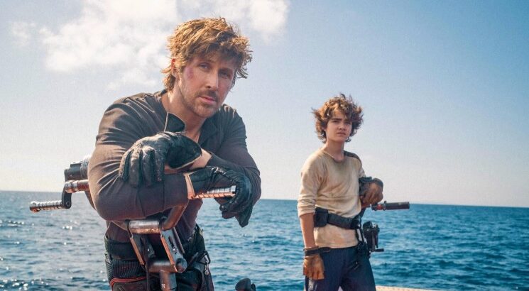 Ryan Gosling and Flynn Gray aboard a water vessel on location in Sardinia filming Star Wars: Starfighter