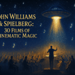 Cinematic banner showing a glowing UFO above an orchestra under a galactic night sky filled with musical-note stars, symbolizing John Williams and Steven Spielberg’s film legacy.