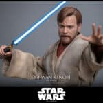 Hot Toys Obi-Wan Kenobi Mustafar sixth-scale figure with blue lightsaber extended over fiery background.