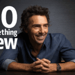 Portrait of director Shawn Levy smiling at a table, with the phrase “Do Something New” in bold white text beside him.