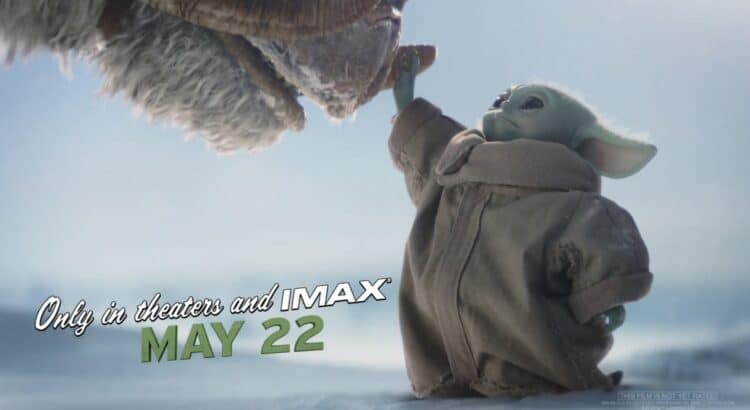 Grogu reaching up toward a creature in a scene from The Mandalorian and Grogu promotional footage