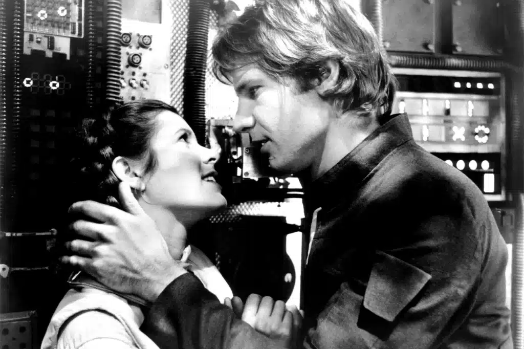 Carrie Fisher and Harrison Ford in a black-and-white behind-the-scenes Star Wars photo