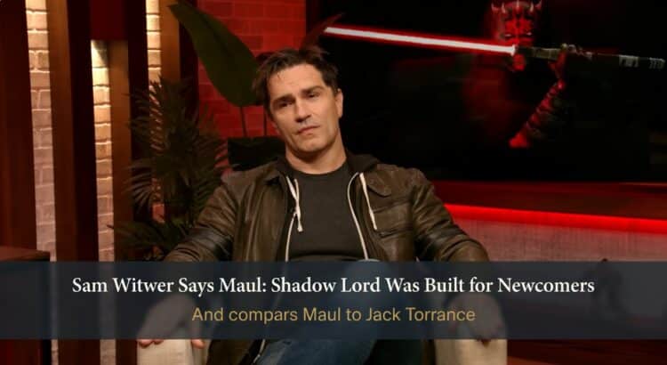 Sam Witwer during an interview discussing Maul: Shadow Lord in a red-lit studio with Darth Maul imagery in the background