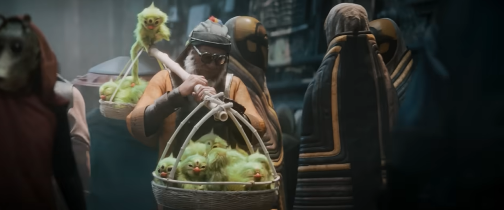 Man carrying baskets of small green creatures