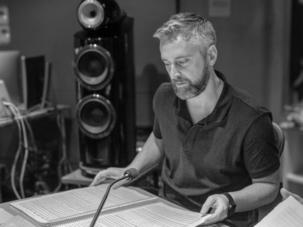 Man reviewing sheet music in recording studio