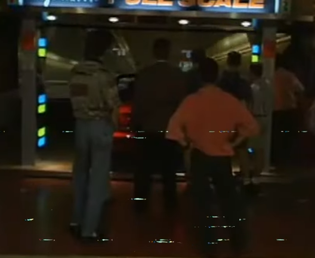 People watching car inside self-serve wash bay