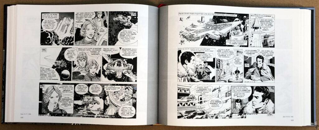 Open book displaying black-and-white comic strips